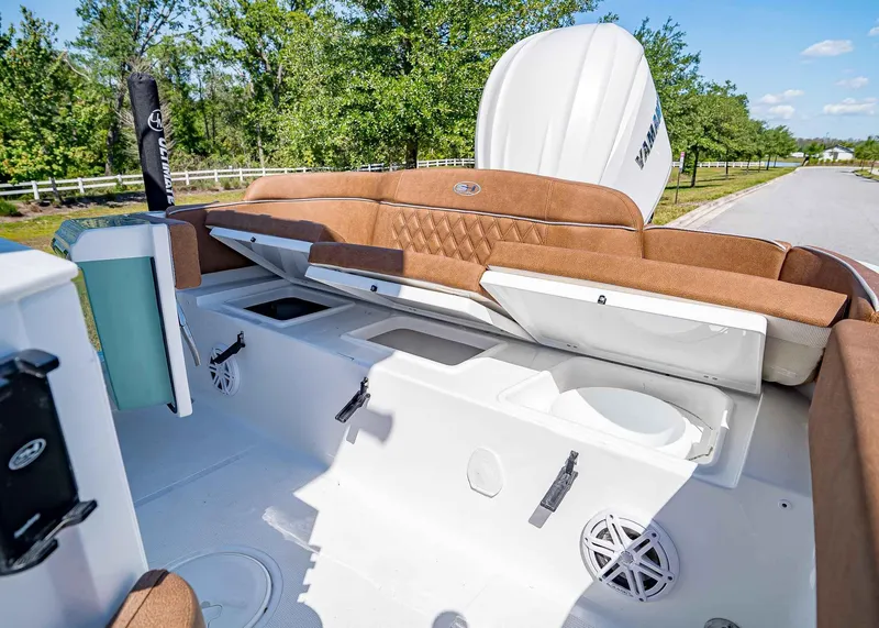 Slide: The Image of 2025 Sea Hunt Ultra 245 SE boat interior with storage compartments and seating. - 10