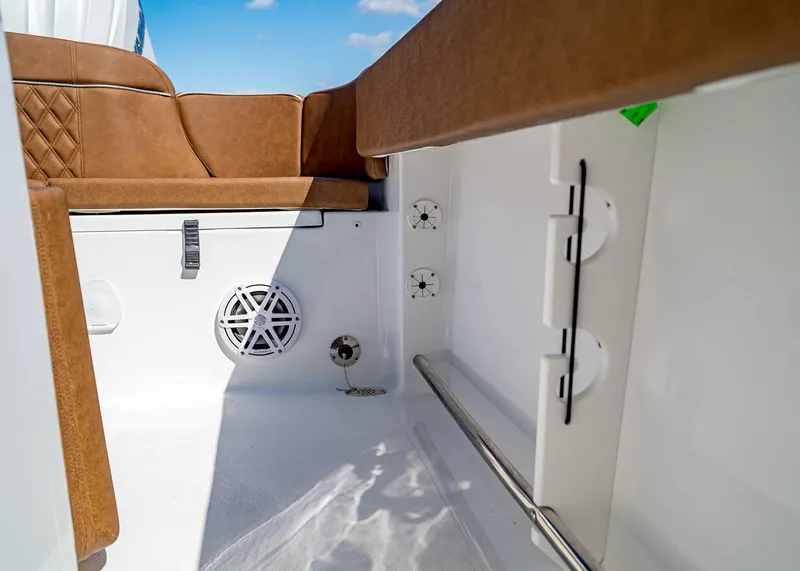 Slide: The Image of Interior of 2025 Sea Hunt Ultra 245 SE boat with brown seating and speaker. - 11