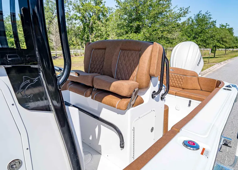 Slide: The Image of 2025 Sea Hunt Ultra 245 SE boat interior with brown cushioned seating and Yamaha engine. - 14