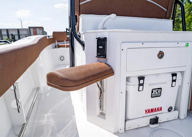 Slide: The Image of 2025 Sea Hunt Ultra 245 SE boat interior with Yamaha cooler and brown seating. - 16