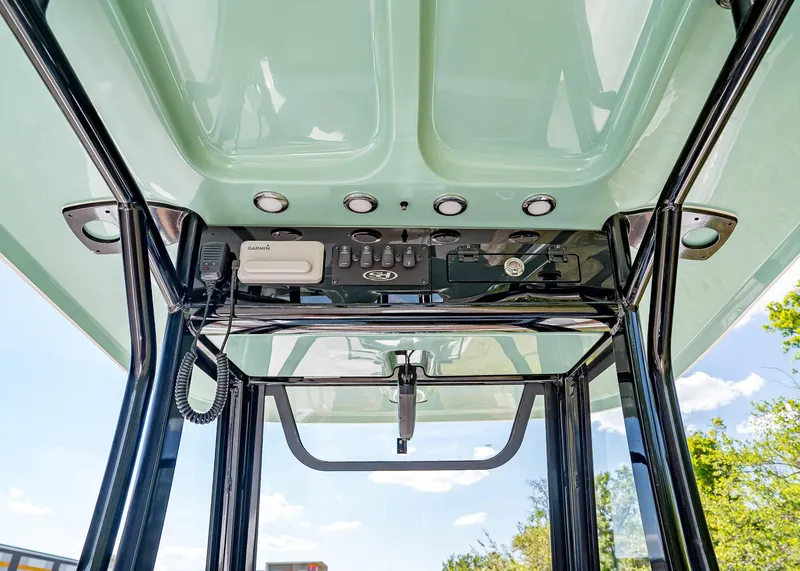 Slide: The Image of 2025 Sea Hunt Ultra 245 SE boat console with Garmin electronics and overhead controls. - 20