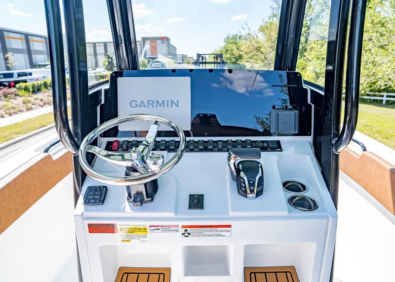 Slide: The Image of 2025 Sea Hunt Ultra 245 SE boat dashboard with Garmin navigation system and steering wheel. - 21