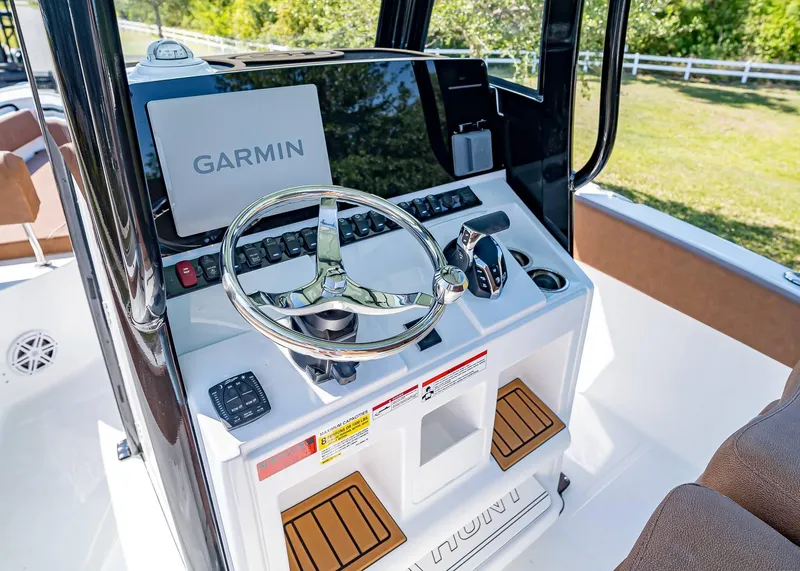 Slide: The Image of 2025 Sea Hunt Ultra 245 SE boat console with Garmin navigation system. - 22