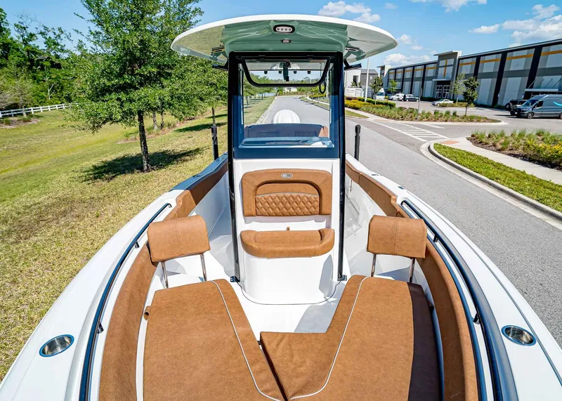Slide: The Image of 2025 Sea Hunt Ultra 245 SE boat interior with brown seating and modern design. - 28