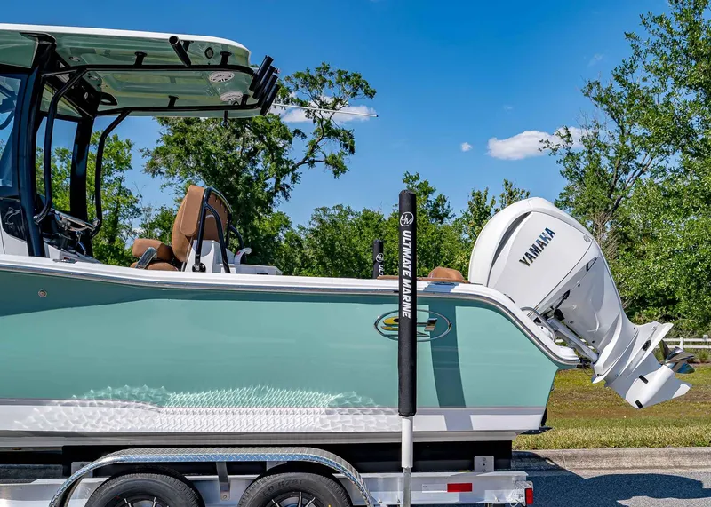 Slide: The Image of 2025 Sea Hunt Ultra 245 SE boat with Yamaha engine on trailer, outdoors. - 3