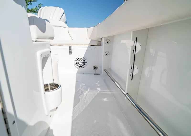 Slide: The Image of Interior view of 2025 Sea Hunt Ultra 245 SE boat, featuring sleek white design and seating. - 11