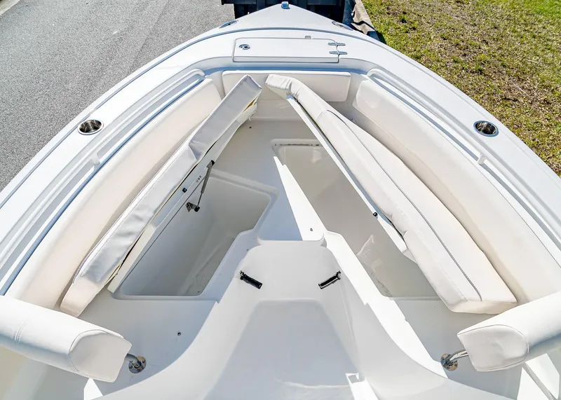 Slide: The Image of 2025 Sea Hunt Ultra 245 SE boat interior with white cushioned seating. - 24