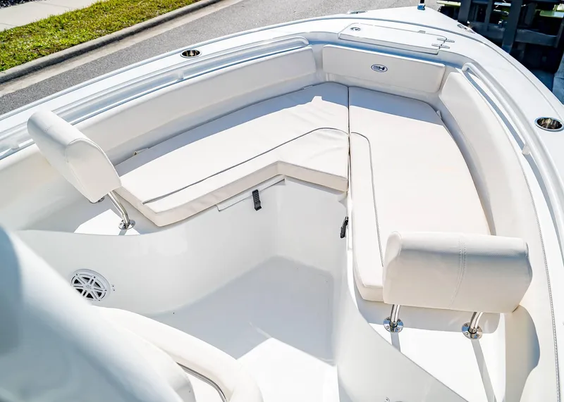 Slide: The Image of 2025 Sea Hunt Ultra 245 SE boat interior with white cushioned seating. - 26