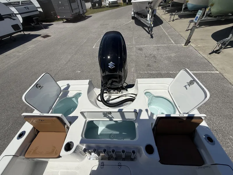 Slide: The Image of 2025 Sea Pro 230 Bay boat with open storage compartments and outboard motor. - 10