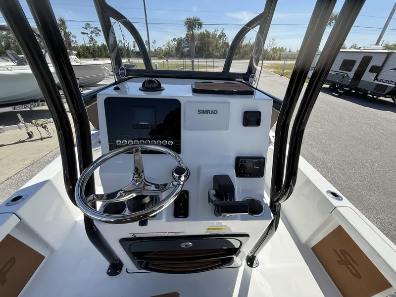 Slide: The Image of 2025 Sea Pro 230 Bay boat console with steering wheel and Simrad electronics. - 12