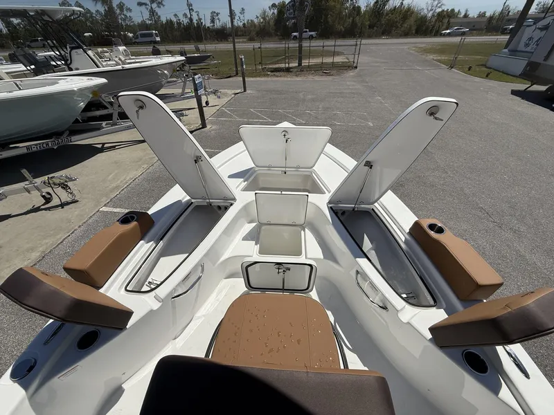 Slide: The Image of 2025 Sea Pro 230 Bay boat interior with open storage compartments and seating. - 5