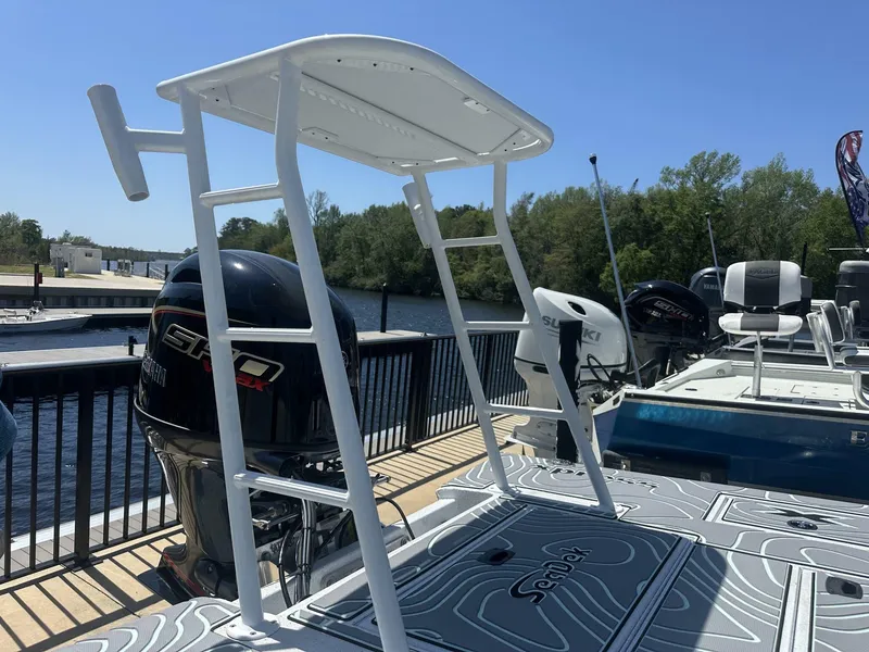 Slide: The Image of 2025 Xpress Skiff 185 boat with outboard motor, docked by a scenic river. - 12