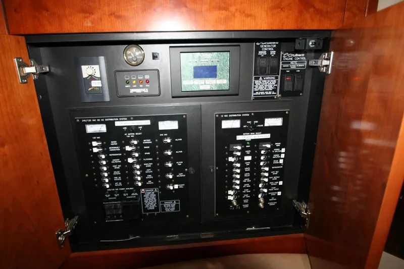 Slide: The Image of Electrical control panel inside 2008 Cruisers Yachts 460 Express, featuring switches and gauges. - 12