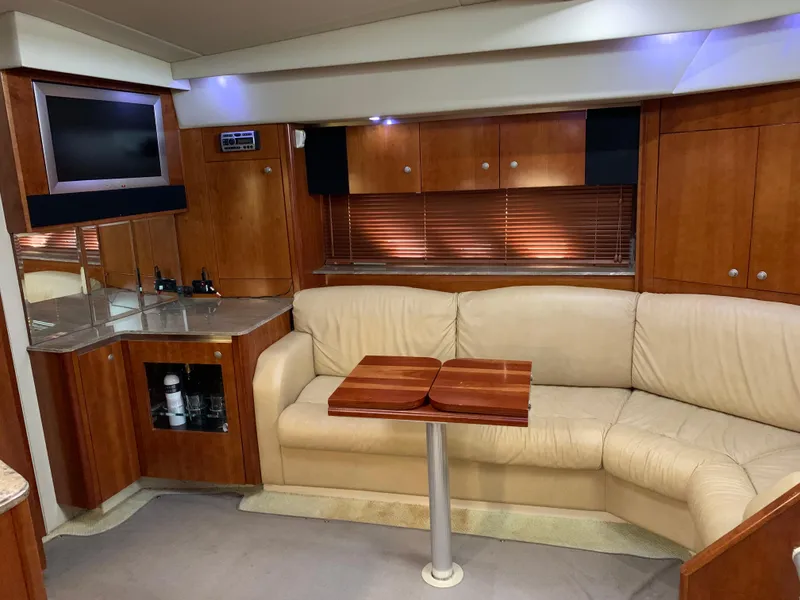 Slide: The Image of Interior of a 2008 Cruisers Yachts 460 Express with leather sofa and wooden table. - 2