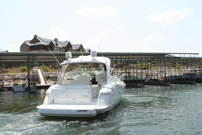 Slide: The Image of 2008 Cruisers Yachts 460 Express in marina, with dock and buildings in background. - 4