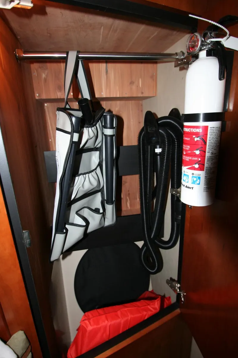 Slide: The Image of Storage compartment in 2008 Cruisers Yachts 460 Express with safety equipment and fire extinguisher. - 13