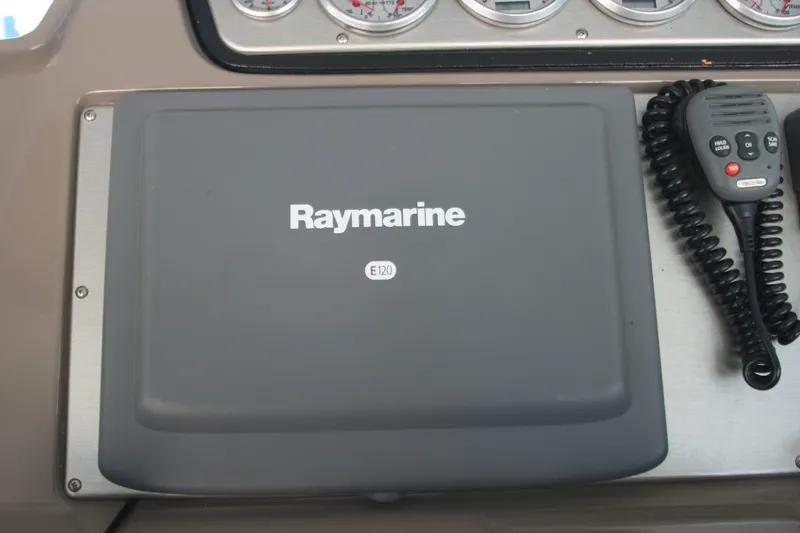 Slide: The Image of Raymarine E120 navigation system on 2008 Cruisers Yachts 460 Express dashboard. - 16