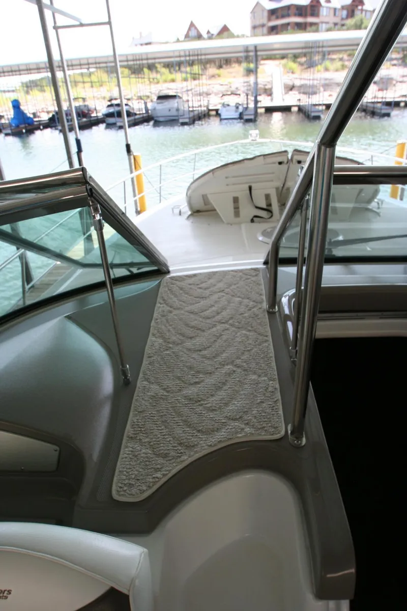Slide: The Image of 2008 Cruisers Yachts 460 Express deck with marina view, featuring sleek design and modern amenities. - 20