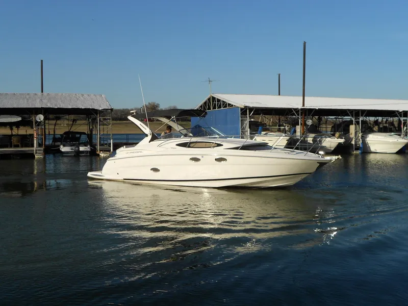 Slide: The Image of 2007 Regal 3360 Window Express boat docked at marina under clear blue sky. - 10