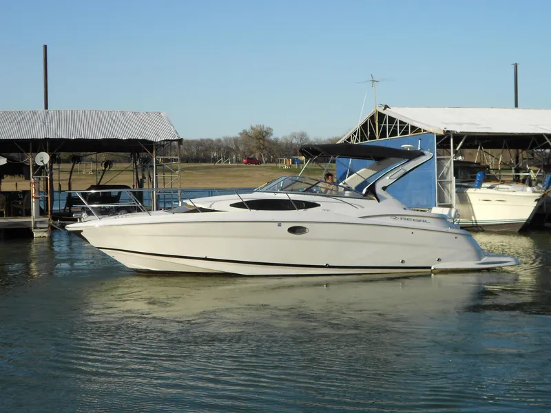 Slide: The Image of 2007 Regal 3360 Window Express boat docked on calm water near marina. - 16