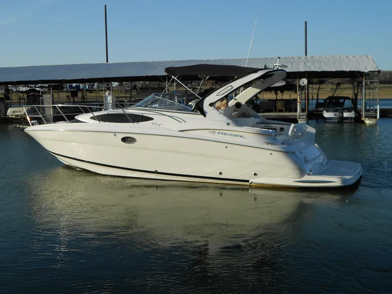 Slide: The Image of 2007 Regal 3360 Window Express boat docked on calm water. - 2