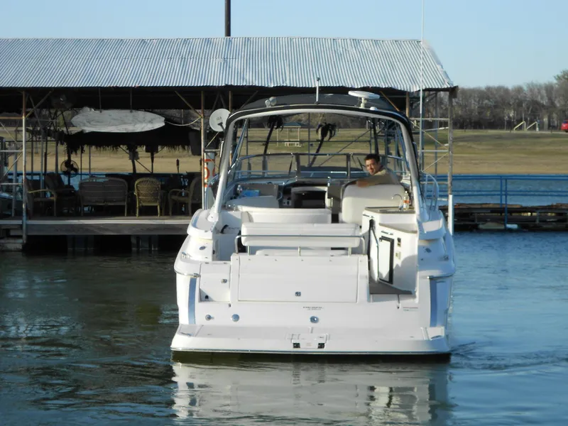 Slide: The Image of 2007 Regal 3360 Window Express boat docked on a calm lake. - 20