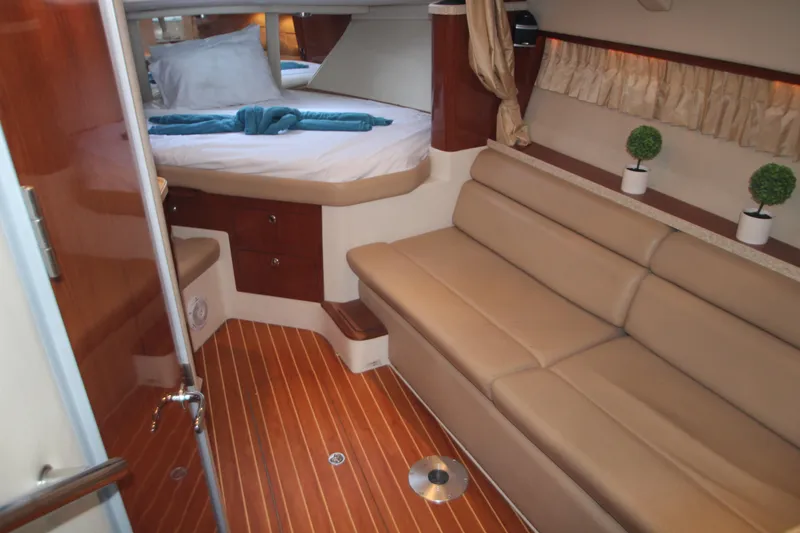 Slide: The Image of 2007 Regal 3360 Window Express cabin interior with bed, sofa, and wooden flooring. - 25