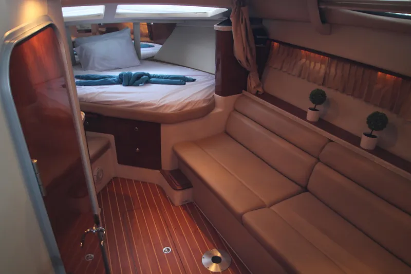 Slide: The Image of Interior of 2007 Regal 3360 Window Express yacht with cozy seating and bed. - 26