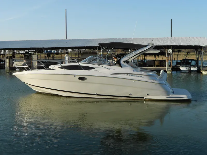 Slide: The Image of 2007 Regal 3360 Window Express boat docked on calm water. - 3