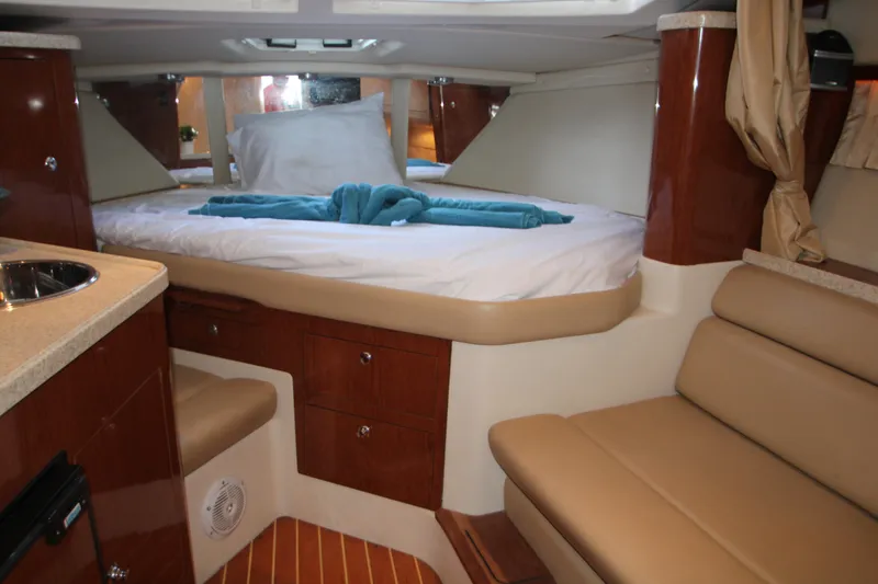 Slide: The Image of 2007 Regal 3360 Window Express cabin interior with bed, seating, and wood accents. - 31