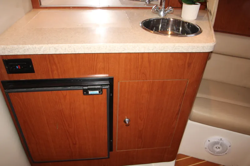 Slide: The Image of 2007 Regal 3360 Window Express boat interior with kitchenette, sink, and mini fridge. - 36