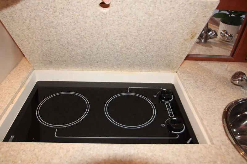 Slide: The Image of 2007 Regal 3360 Window Express boat kitchen with a two-burner electric stove. - 37