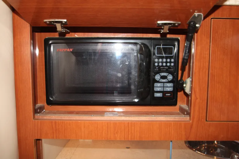 Slide: The Image of Microwave in 2007 Regal 3360 Window Express boat's wooden cabinet. - 38