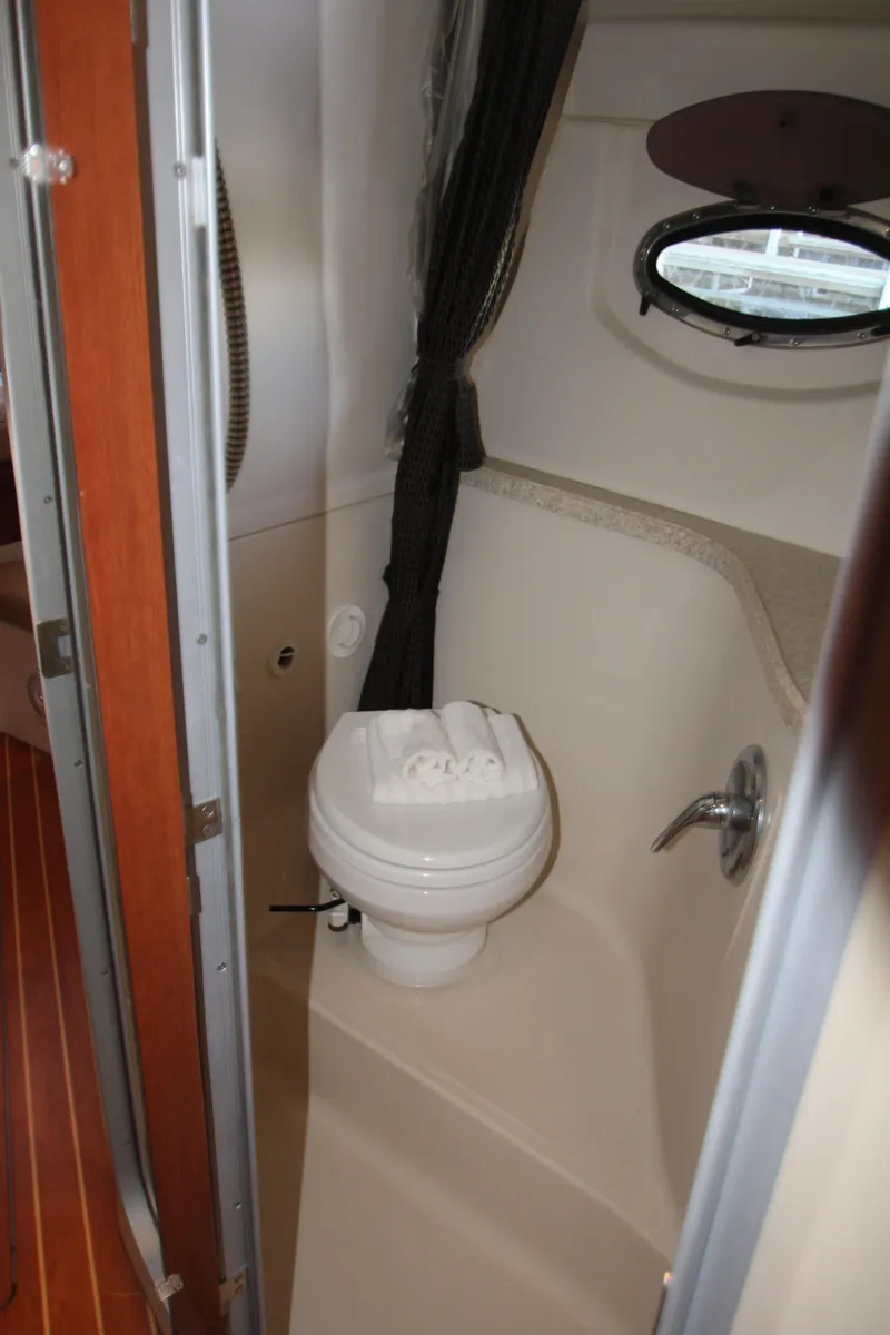 Slide: The Image of 2007 Regal 3360 Window Express boat bathroom interior with porthole and toilet. - 39