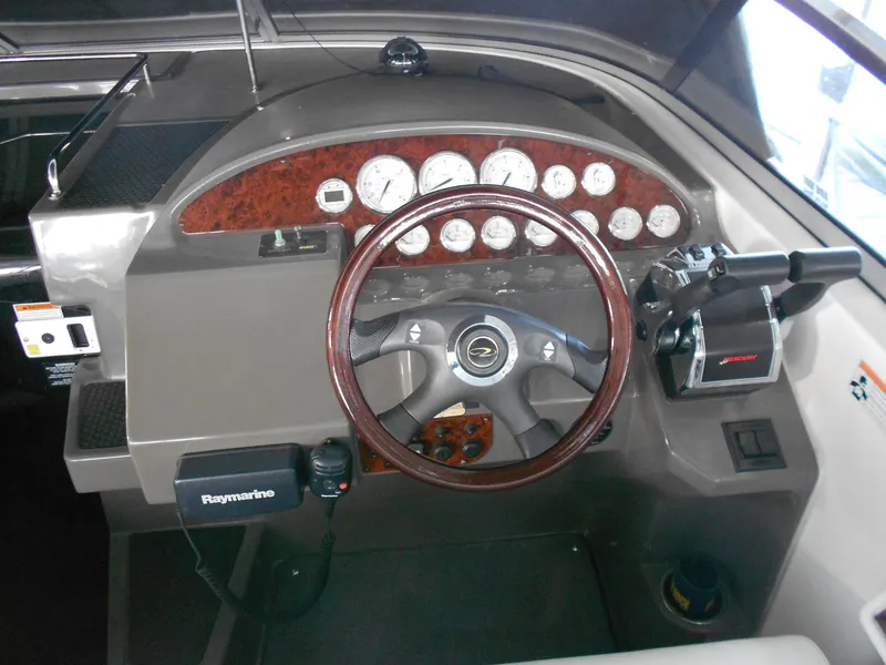 Slide: The Image of 2007 Regal 3360 Window Express boat dashboard with steering wheel and control panel. - 41
