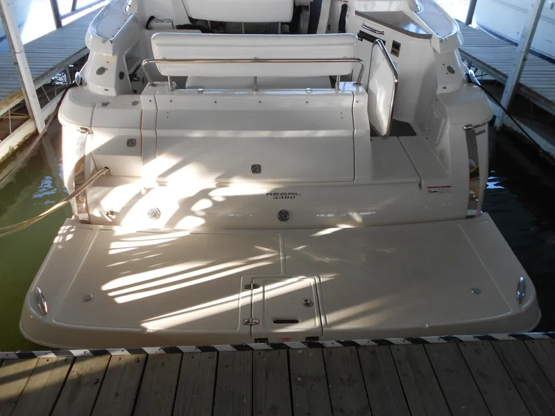 Slide: The Image of 2007 Regal 3360 Window Express boat docked, rear view showing swim platform. - 42