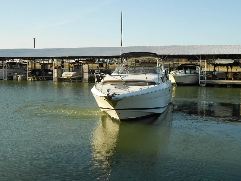 Slide: The Image of 2007 Regal 3360 Window Express boat docked in a marina under clear skies. - 5