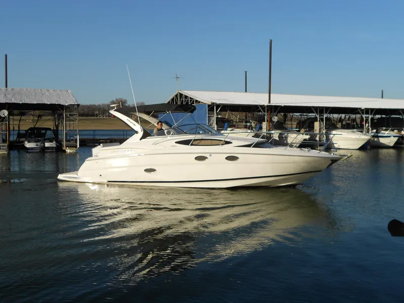 Slide: The Image of 2007 Regal 3360 Window Express boat docked on calm water. - 9