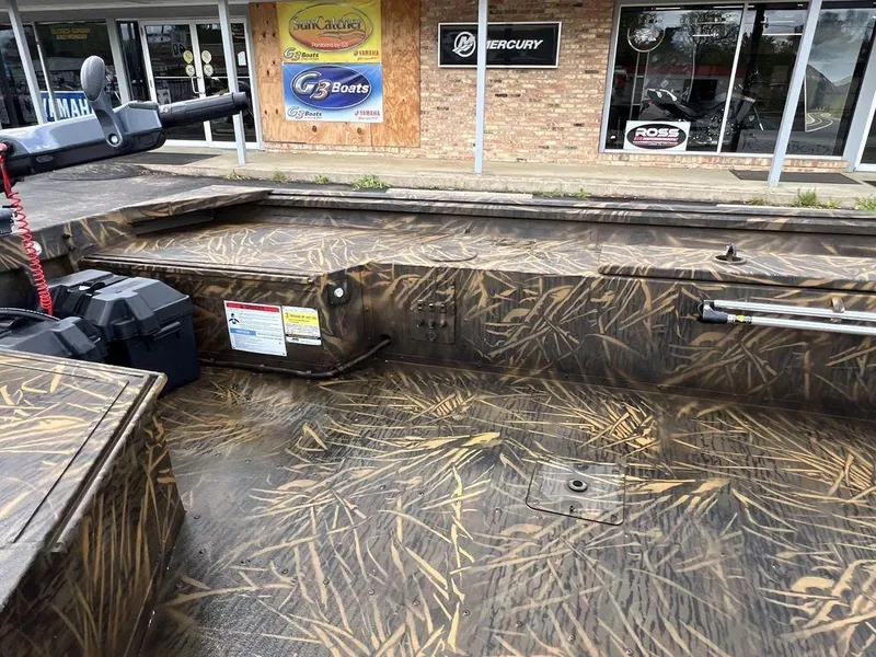 Slide: The Image of 2025 G3 16 dk boat with camouflage design, displayed outside a dealership. - 11