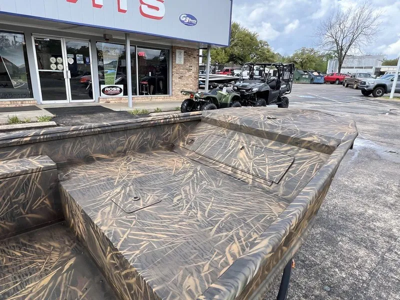 Slide: The Image of Camo-patterned G3 16 dk boat, 2025 model, displayed outside a dealership. - 12