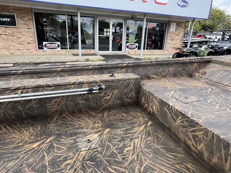 Slide: The Image of Camouflage-patterned G3 16 dk boat, 2025 model, displayed outside a dealership. - 13