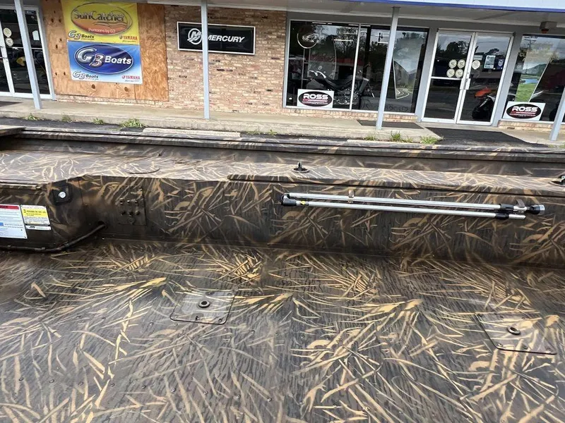 Slide: The Image of Camouflage-patterned G3 16 dk boat, 2025 model, displayed outside a dealership. - 14