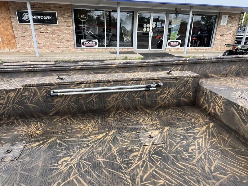 Slide: The Image of Camouflage-patterned interior of a 2025 G3 16 dk boat outside a dealership. - 15