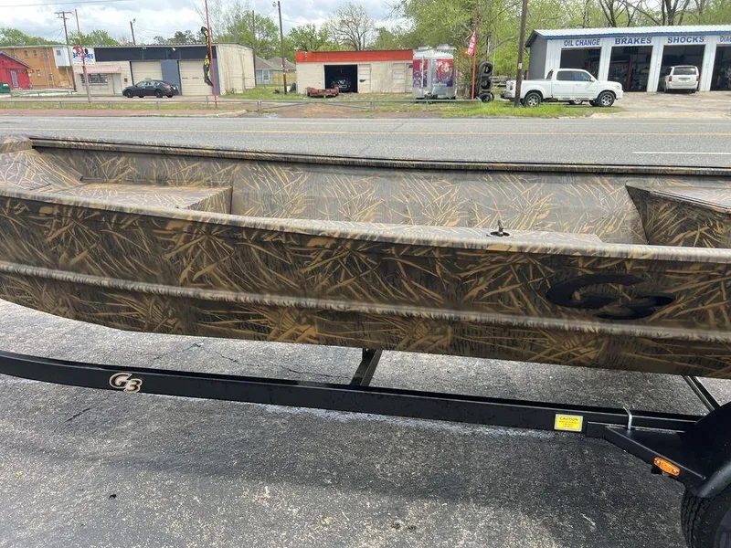 Slide: The Image of 2025 G3 16 dk boat with camouflage design on a trailer, parked near a road. - 37