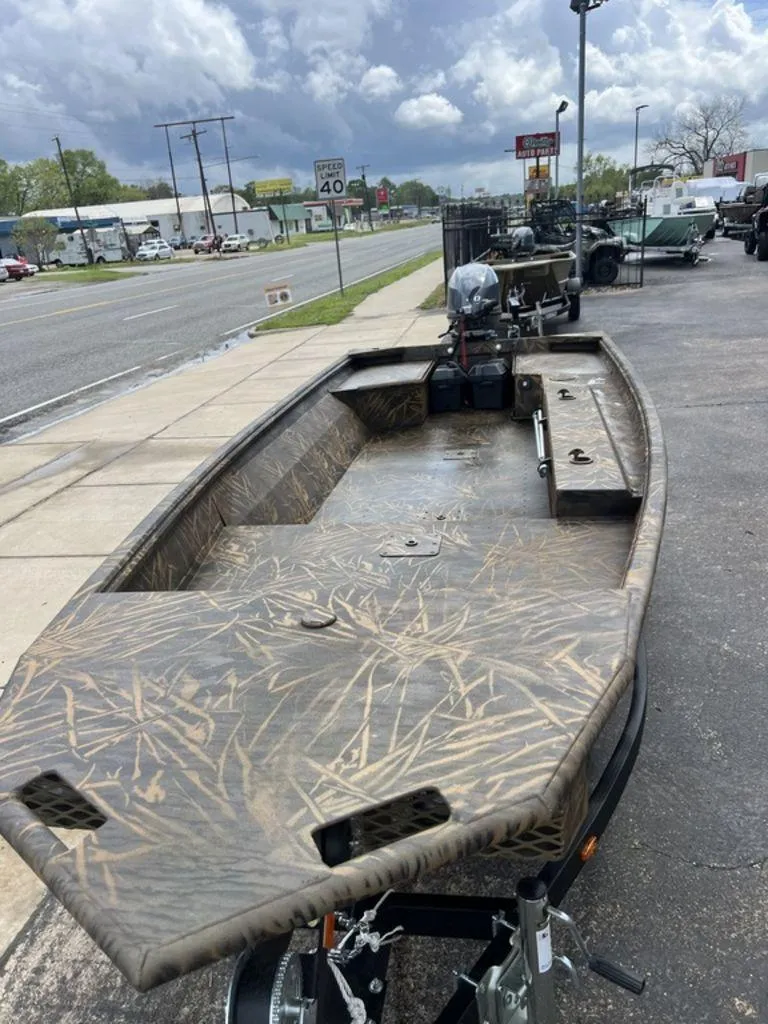 Slide: The Image of 2025 G3 16 dk boat with camouflage design on a trailer, parked roadside. - 46