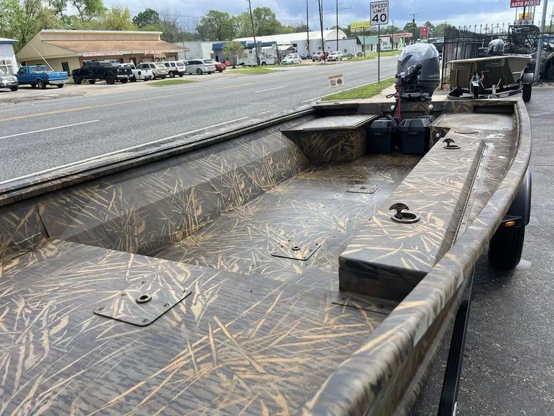 Slide: The Image of Camouflage-patterned G3 16 dk boat, 2025 model, parked on roadside with visible motor. - 48