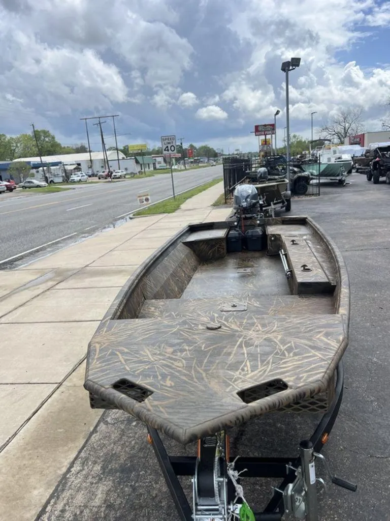 Slide: The Image of 2025 G3 16 dk boat on trailer, parked roadside under cloudy sky. - 49