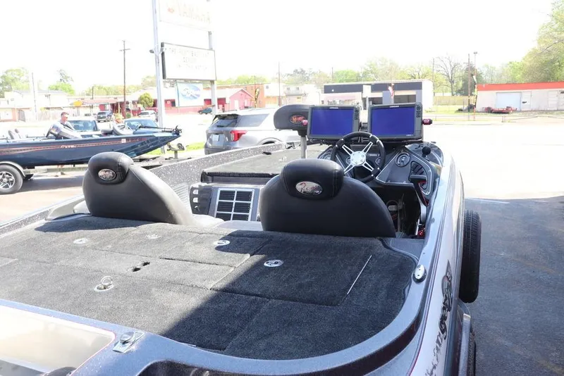 Slide: The Image of 2011 Ranger 518 boat interior with dual screens and steering wheel, parked outdoors. - 16