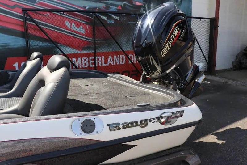 Slide: The Image of 2011 Ranger 518 boat with sleek design and powerful engine, parked outdoors. - 19