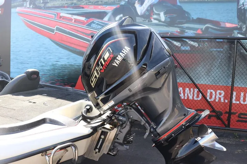 Slide: The Image of 2011 Ranger 518 boat with Yamaha VMAX SHO outboard motor, displayed outdoors. - 2